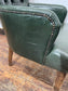 Pair of green leather armchairs with button backs