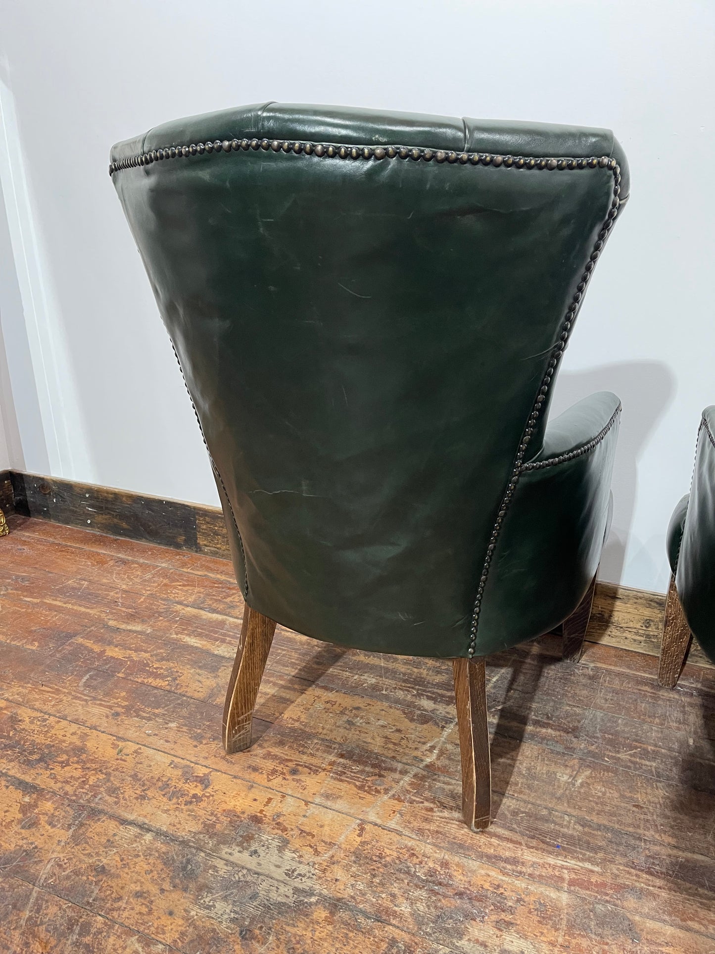 Pair of green leather armchairs with button backs