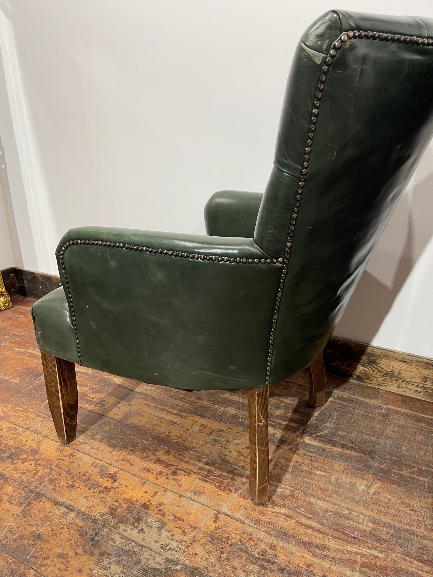 Pair of green leather armchairs with button backs