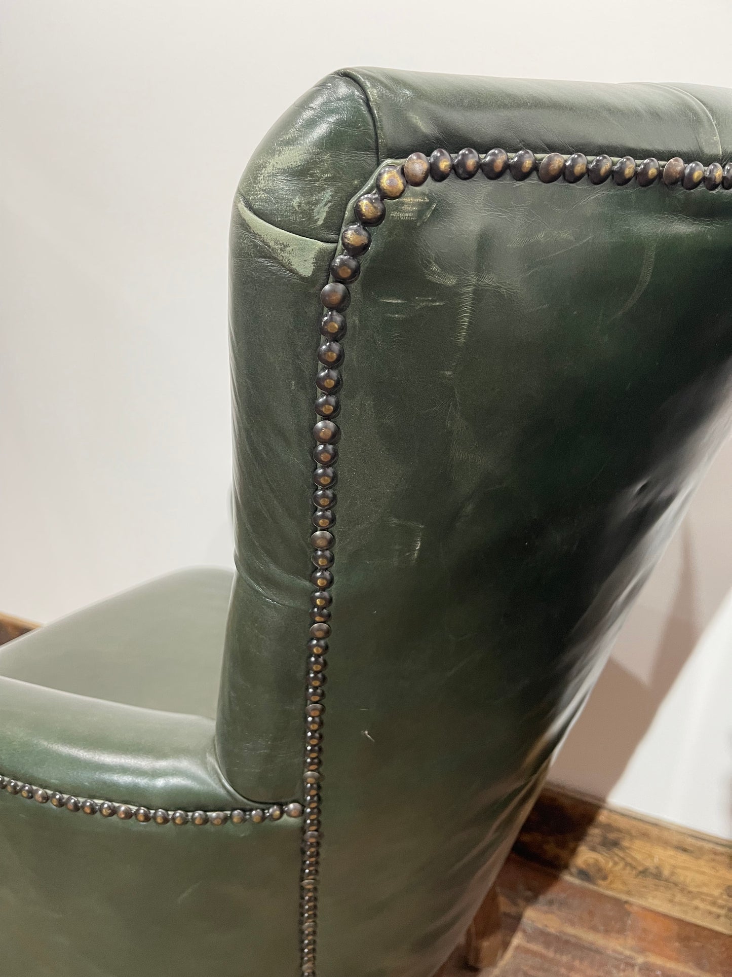 Pair of green leather armchairs with button backs