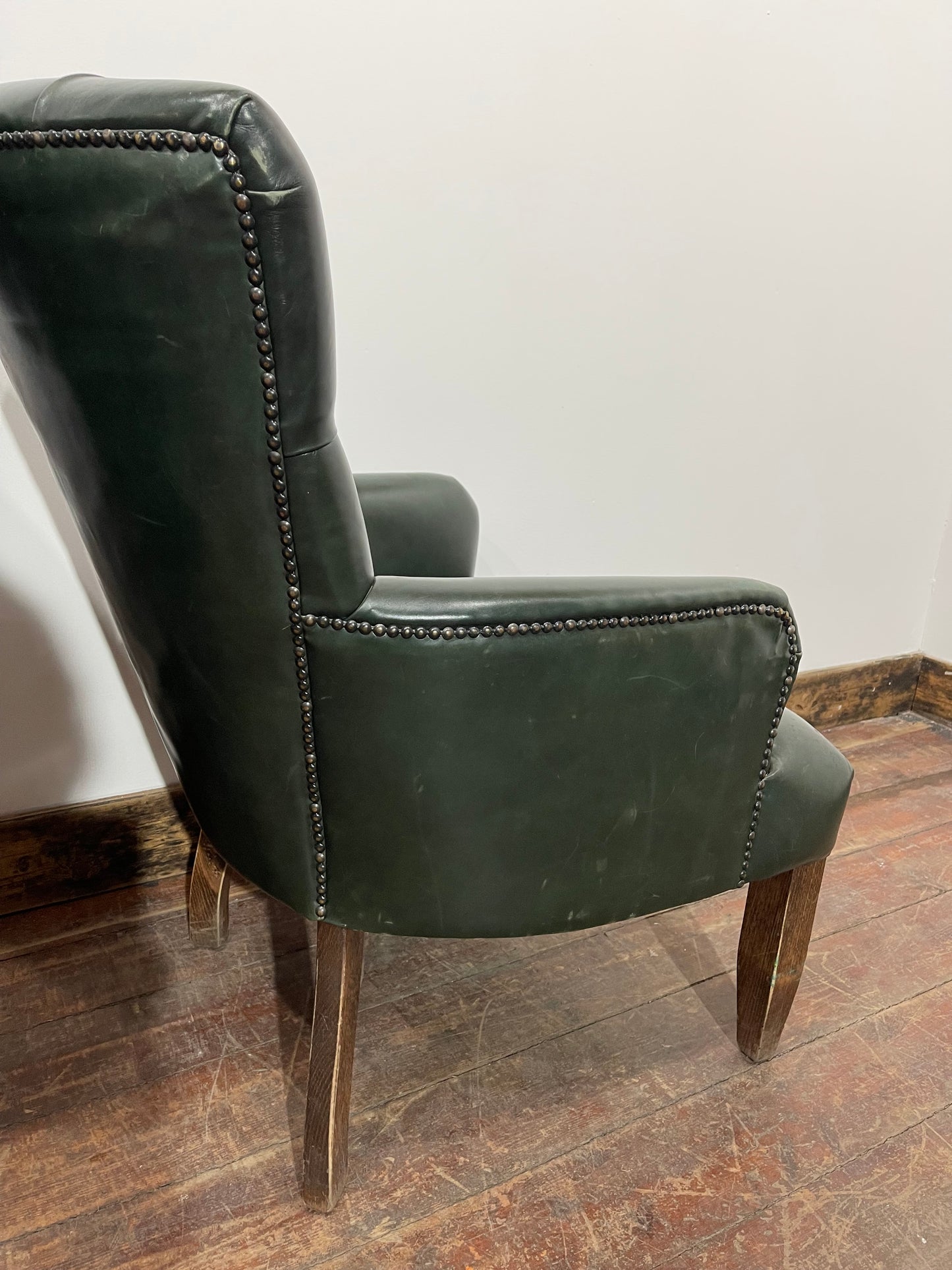 Pair of green leather armchairs with button backs