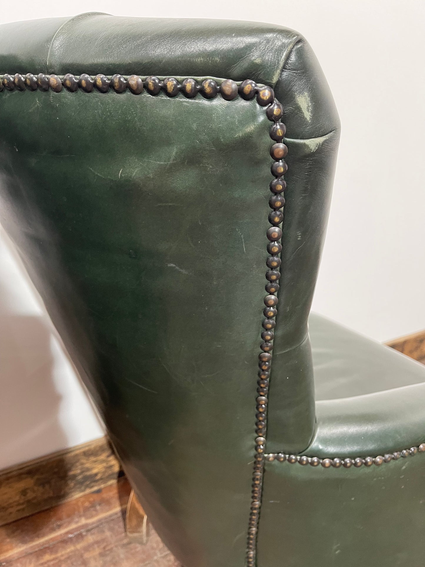 Pair of green leather armchairs with button backs