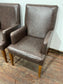 Matching pair of brown faux-leather armchairs