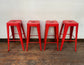 4 red metal stools