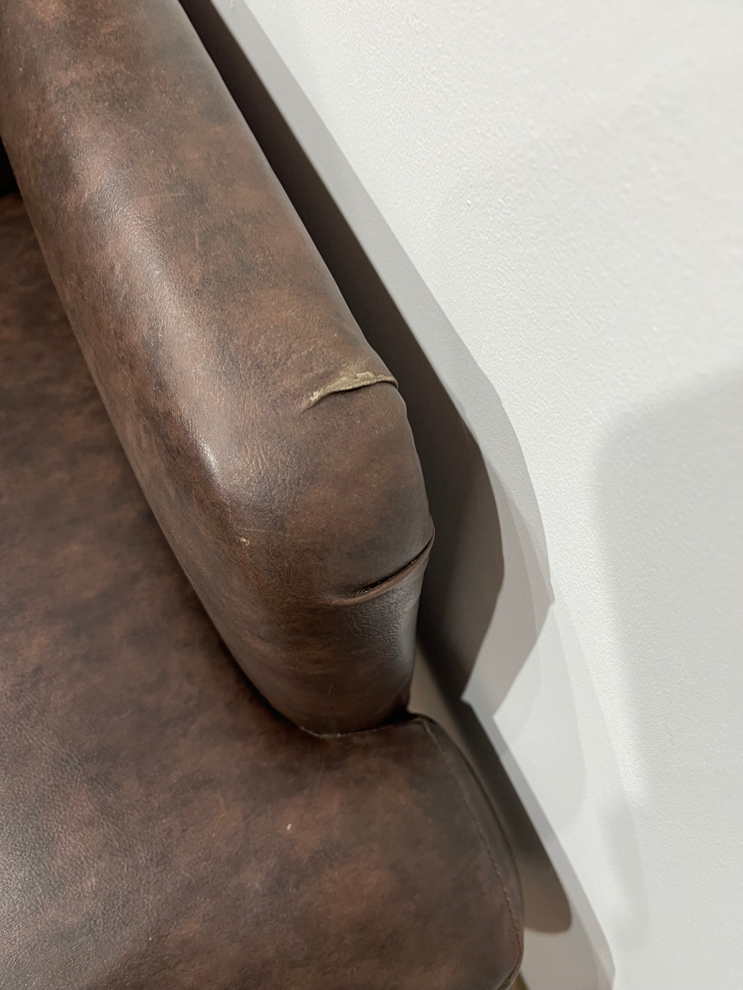 Matching pair of brown faux-leather armchairs