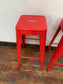 4 red metal stools