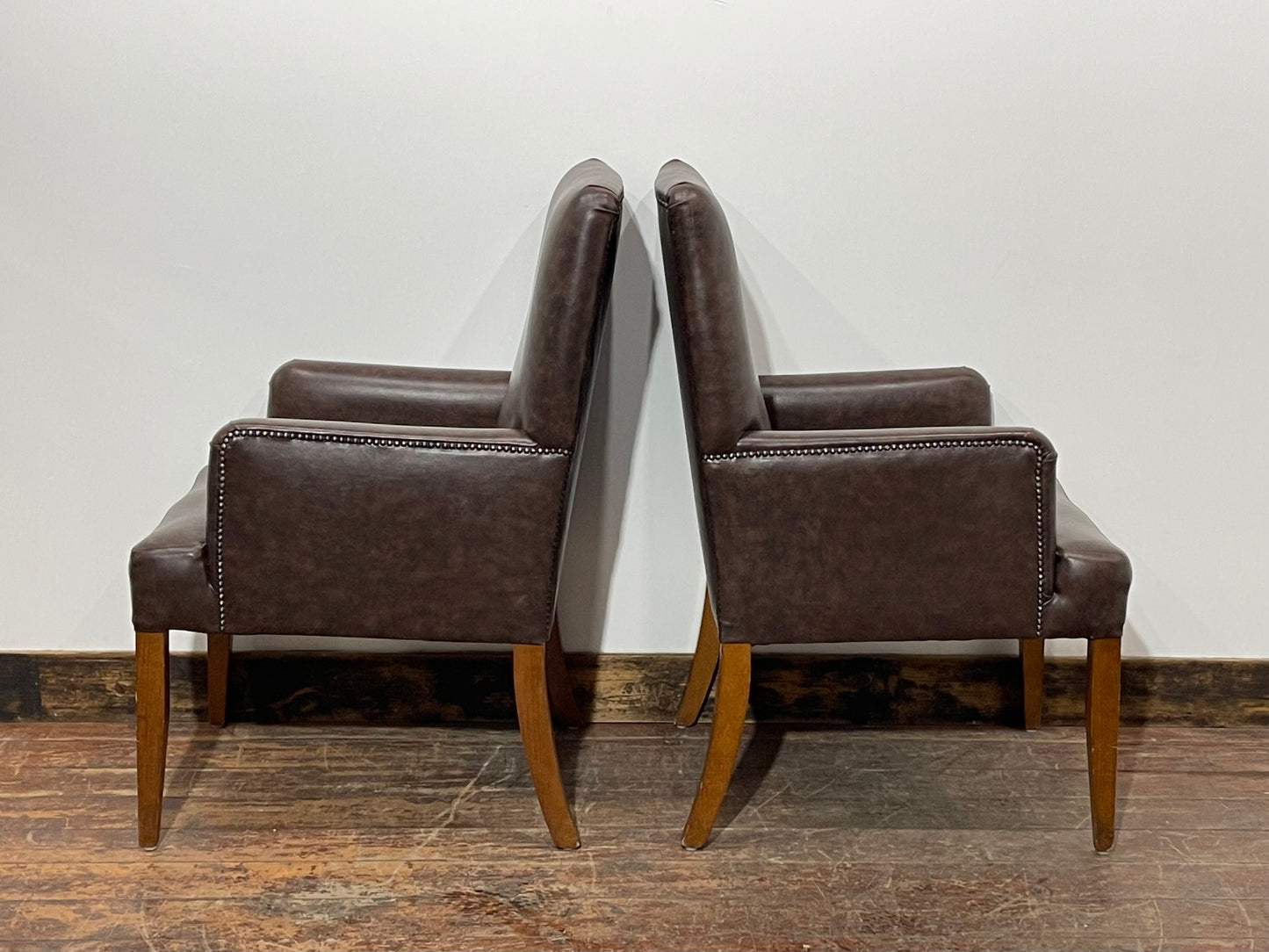 Matching pair of brown faux-leather armchairs