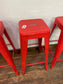 4 red metal stools