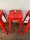 4 red metal stools
