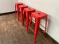 4 red metal stools