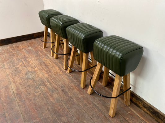 Set of 4 green leather pommel stools