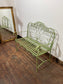 Ornate garden bench in green painted metal