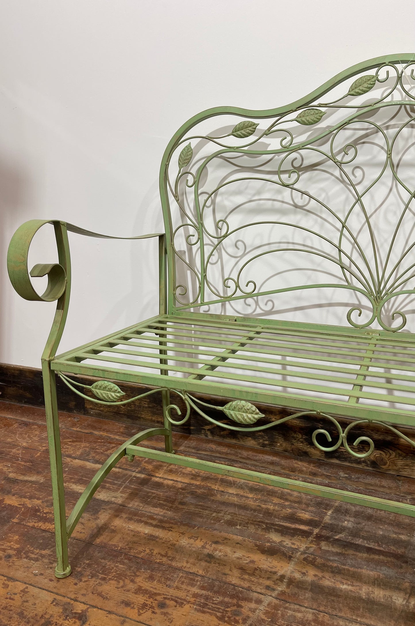 Ornate garden bench in green painted metal