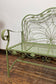 Ornate garden bench in green painted metal
