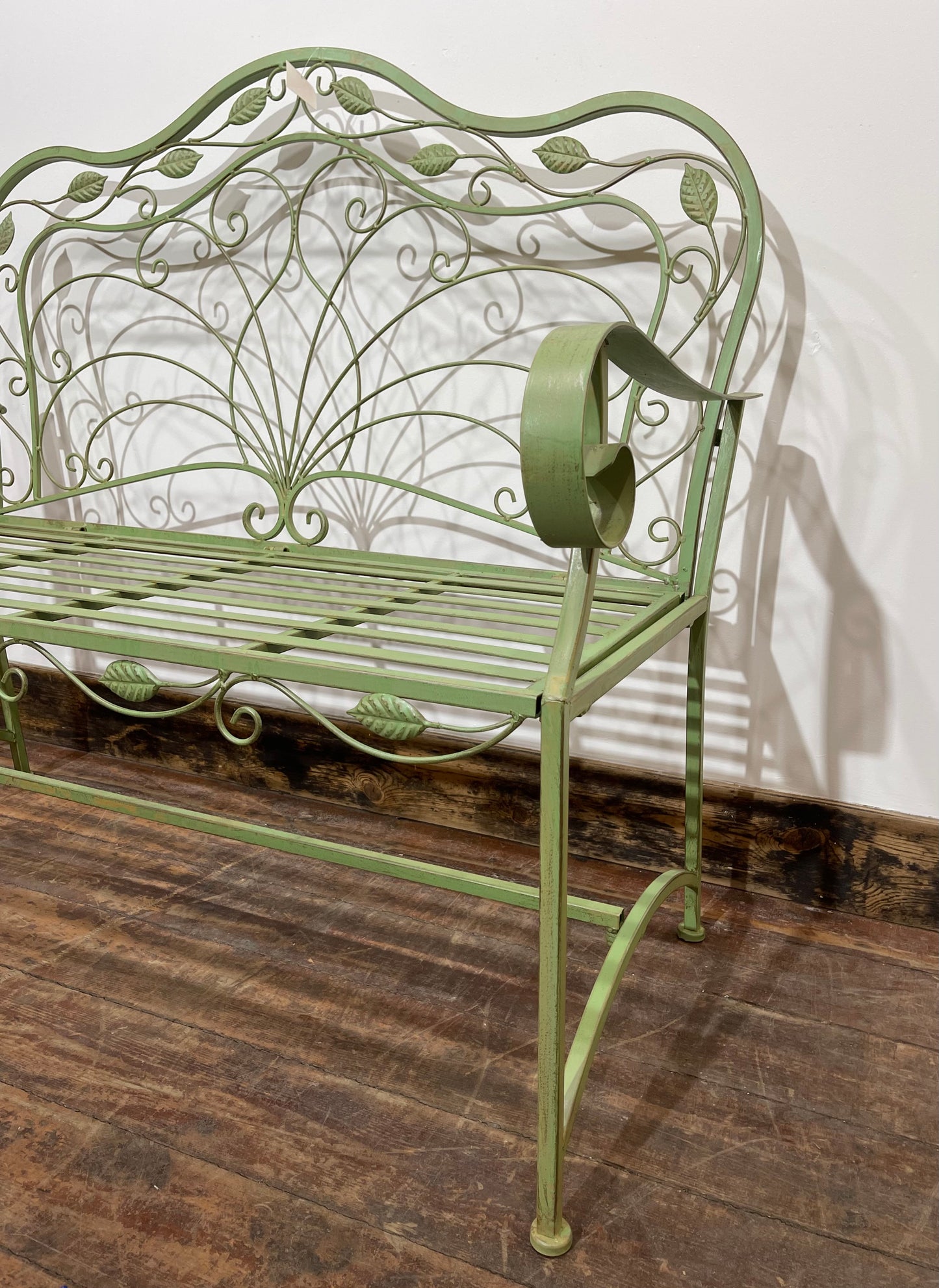 Ornate garden bench in green painted metal