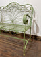 Ornate garden bench in green painted metal