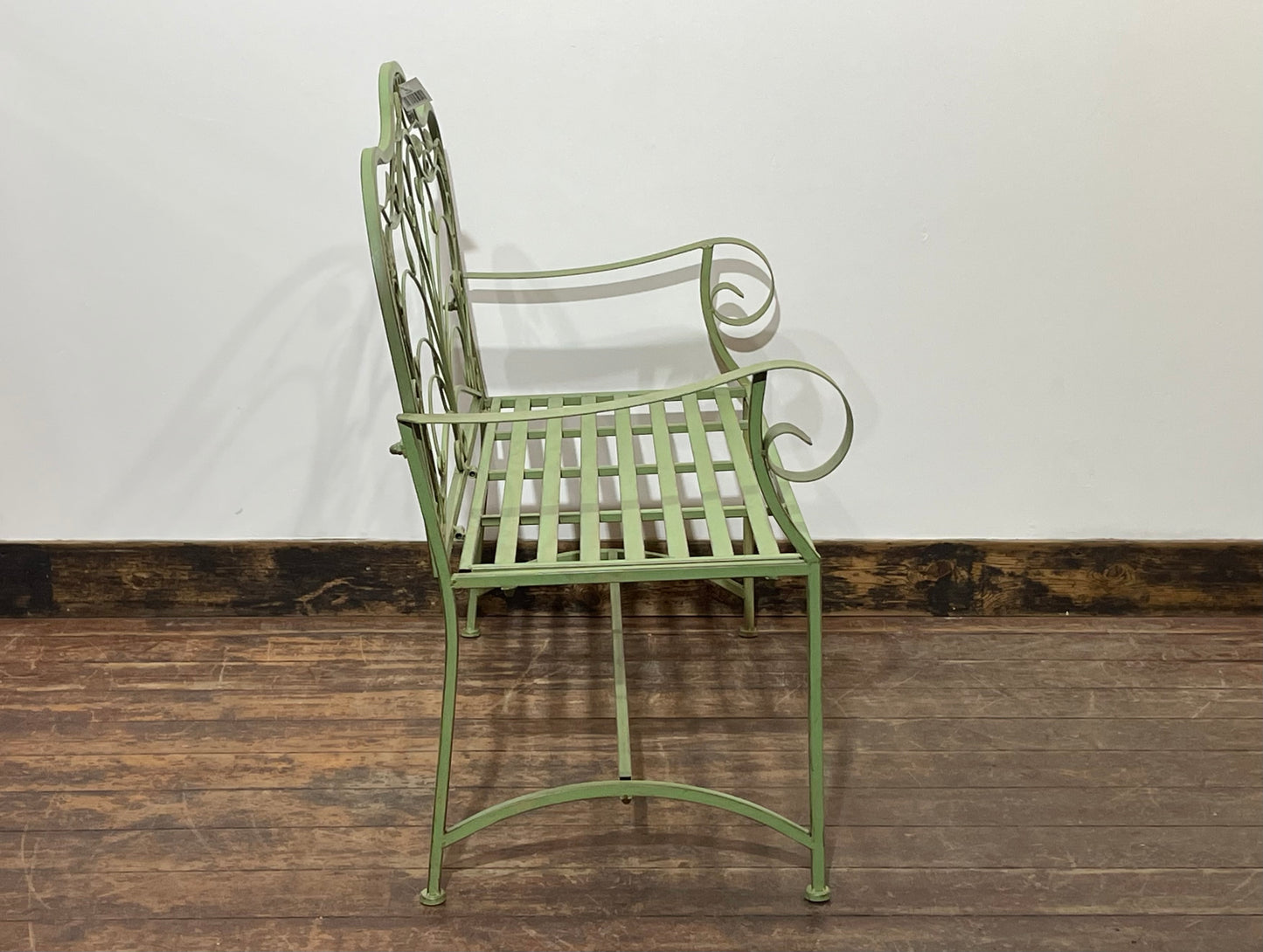 Ornate garden bench in green painted metal
