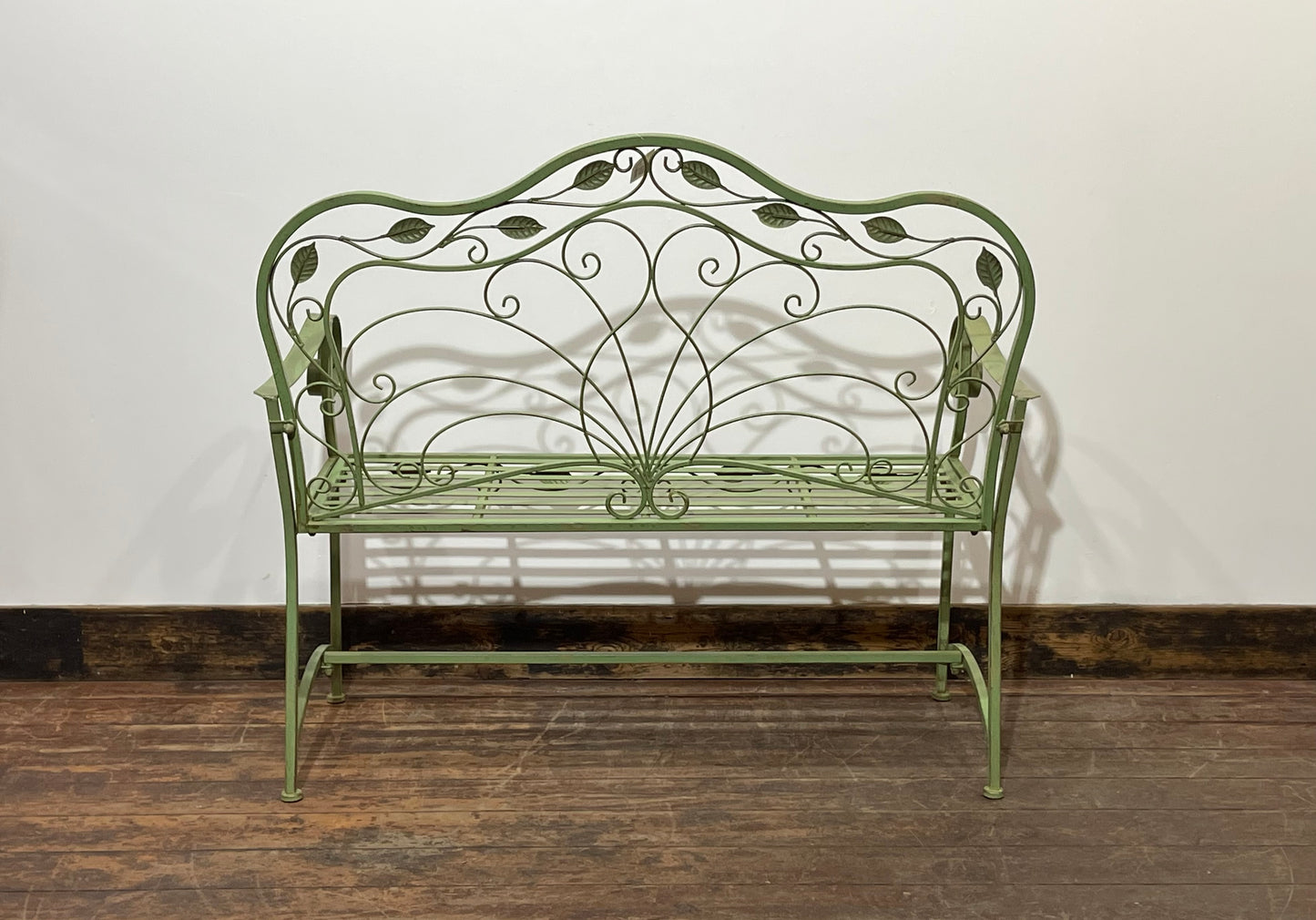 Ornate garden bench in green painted metal
