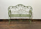 Ornate garden bench in green painted metal