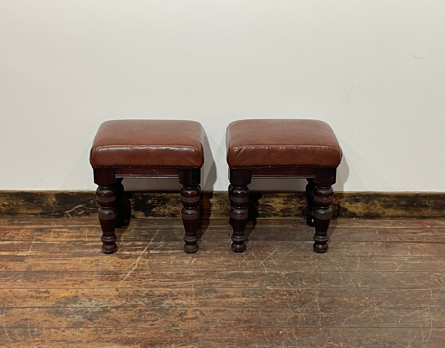 Pair of low pub stools in tan coloured faux-leather