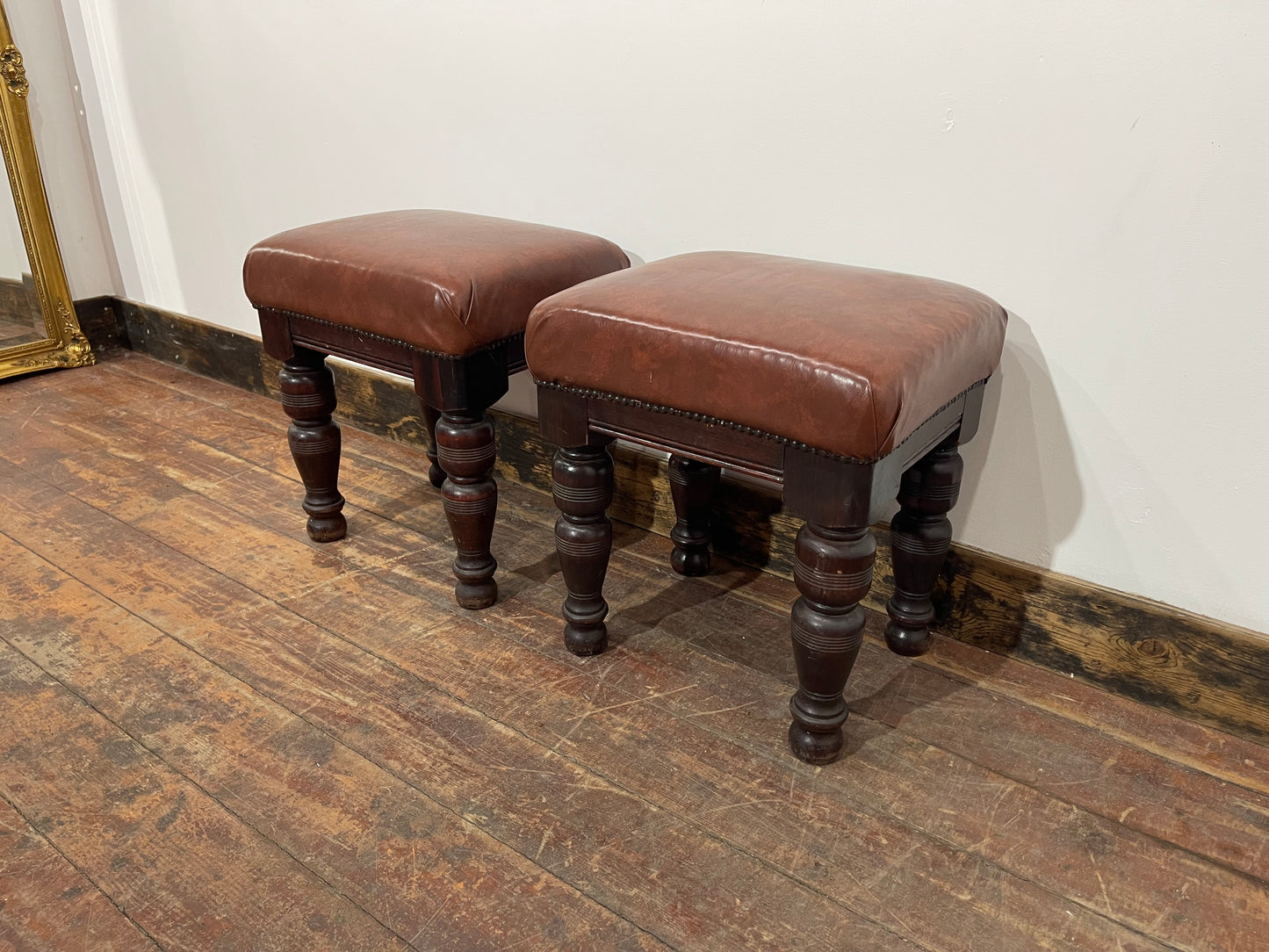 Pair of low pub stools in tan coloured faux-leather
