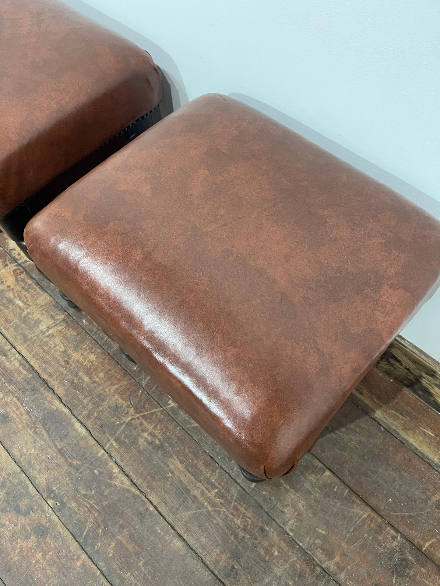 Pair of low pub stools in tan coloured faux-leather