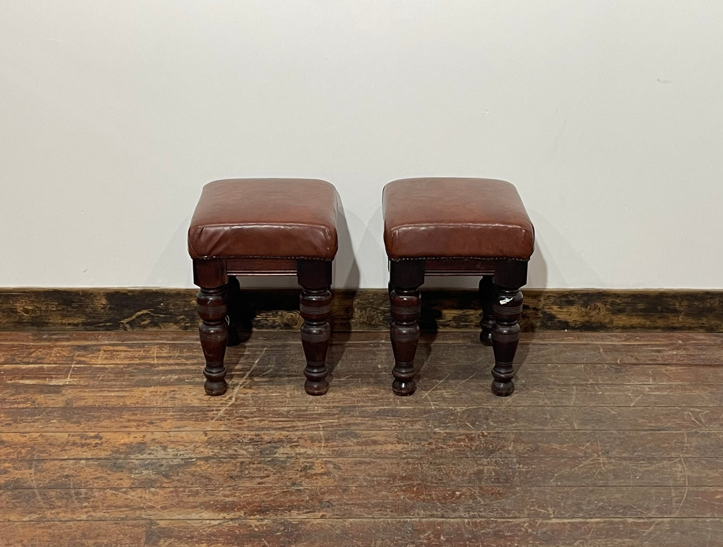 Pair of low pub stools in tan coloured faux-leather