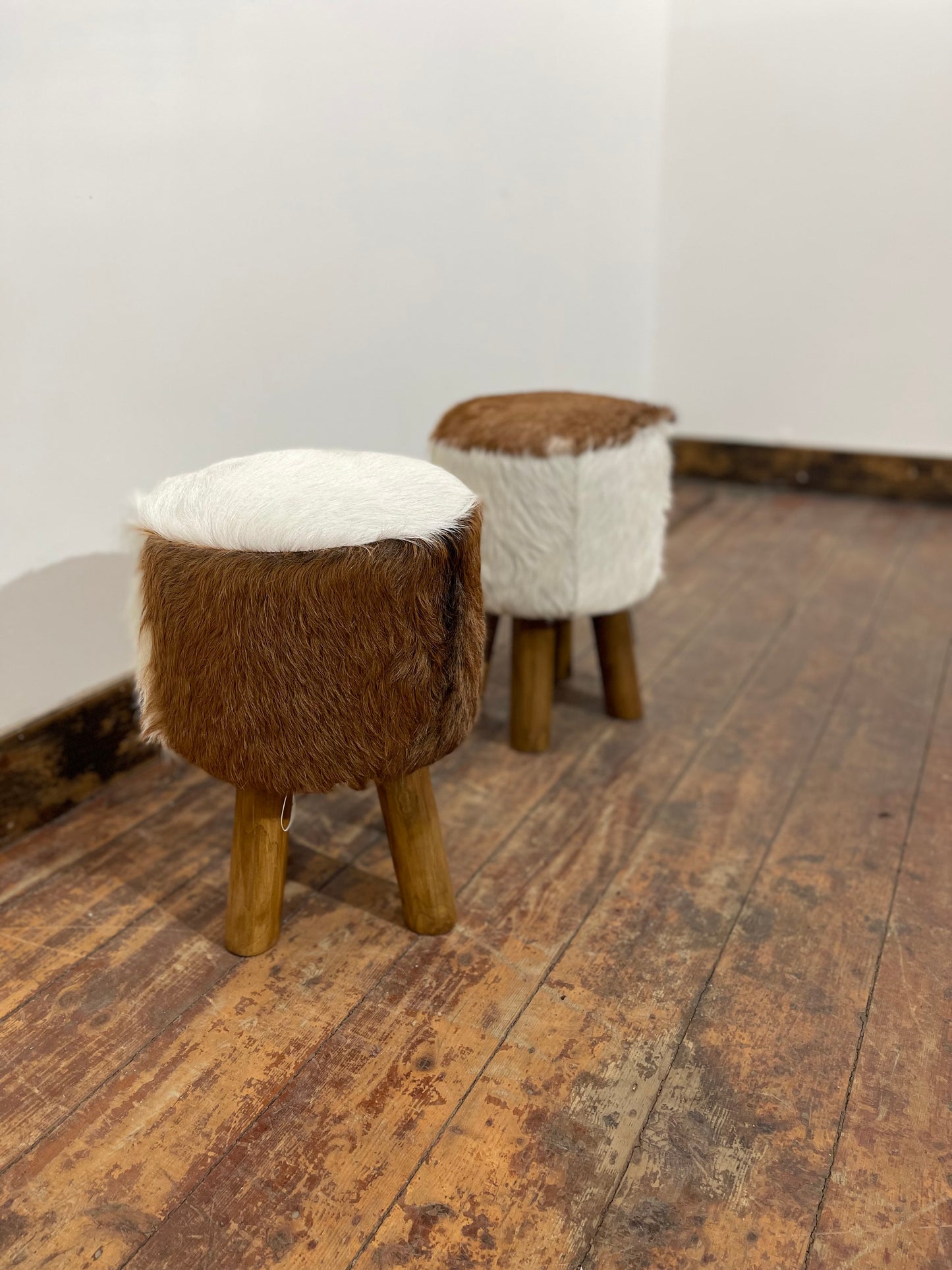 Pair of low cow hide stools