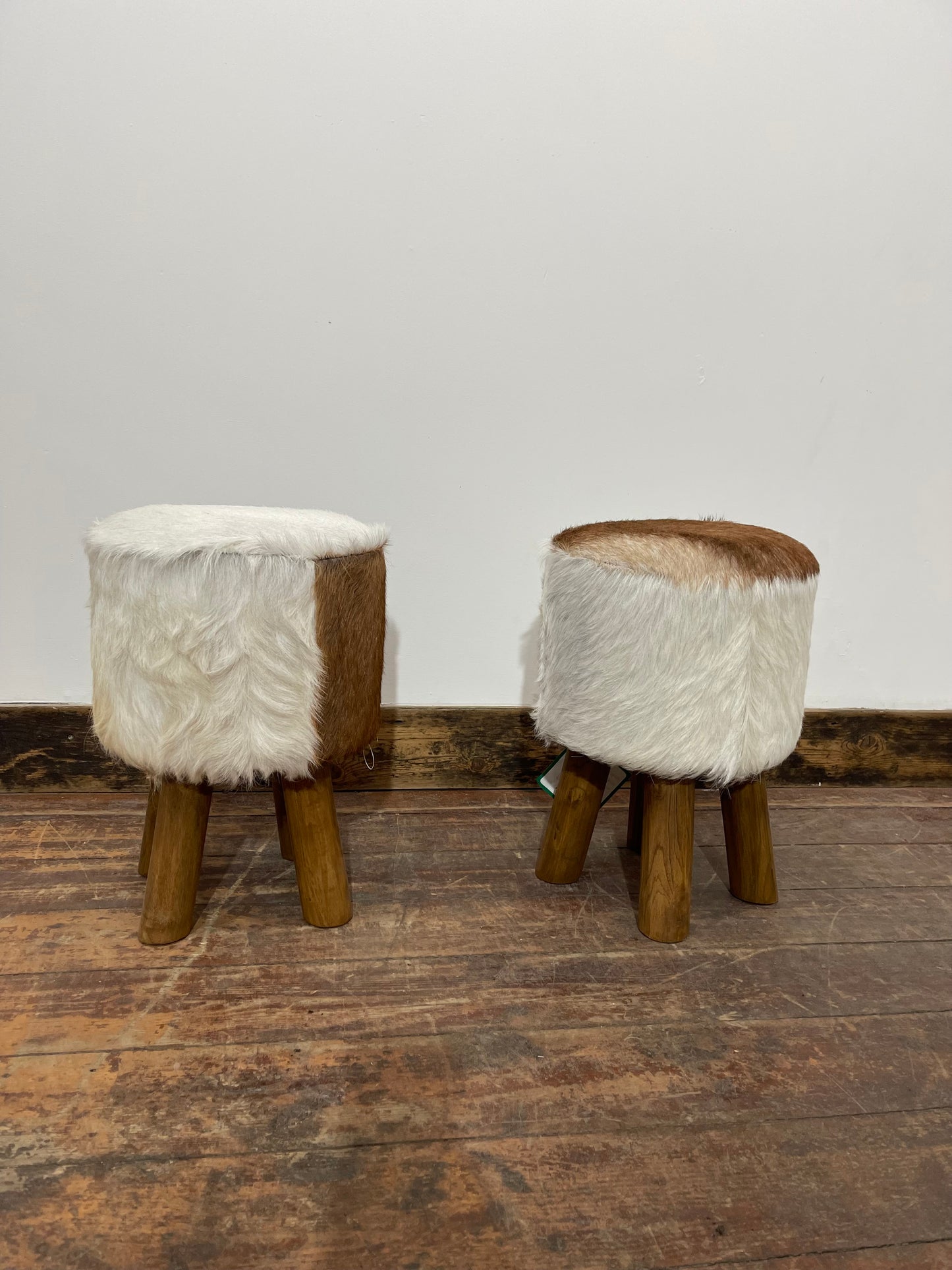 Pair of low cow hide stools