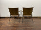 Pair of tan leather armchairs with metal frame