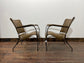 Pair of tan leather armchairs with metal frame