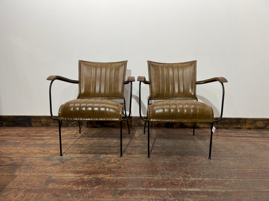 Pair of tan leather armchairs with metal frame