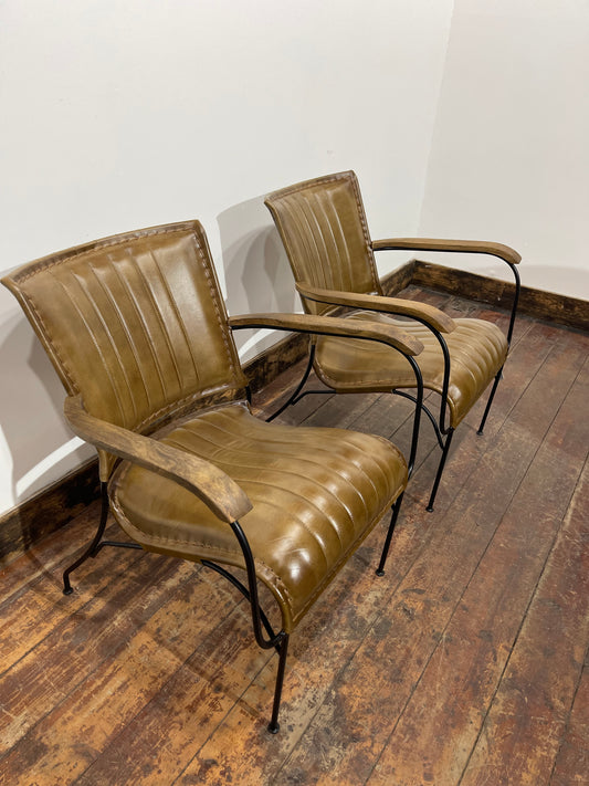 Pair of tan leather armchairs with metal frame