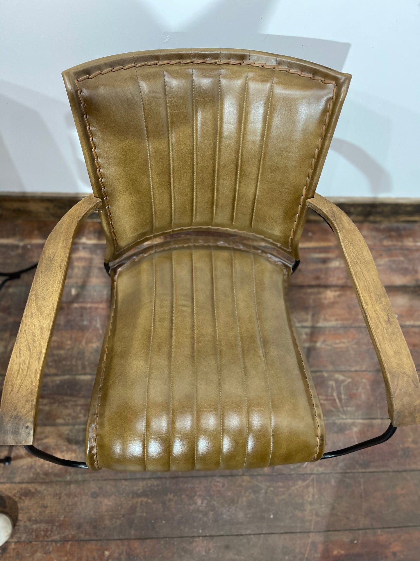 Pair of tan leather armchairs with metal frame