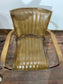 Pair of tan leather armchairs with metal frame