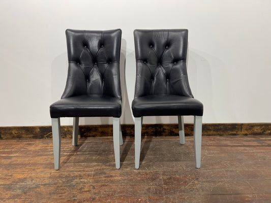 Pair of high back black studded chairs
