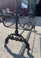 Pair of black metal shelving racks on wheels