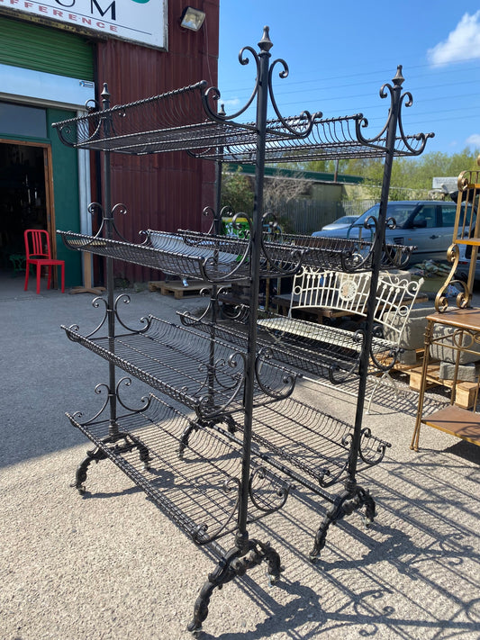 Pair of black metal shelving racks on wheels