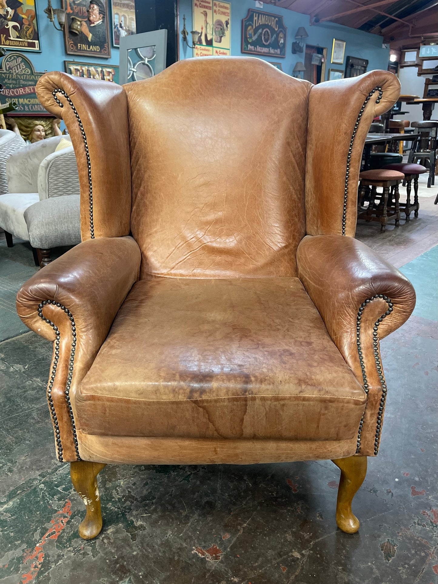 Tan leather wingback armchair