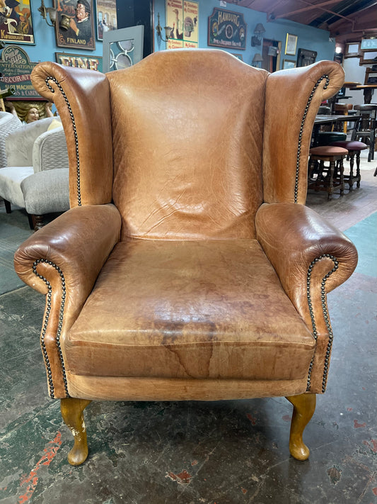 Tan leather wingback armchair