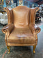 Tan leather wingback armchair