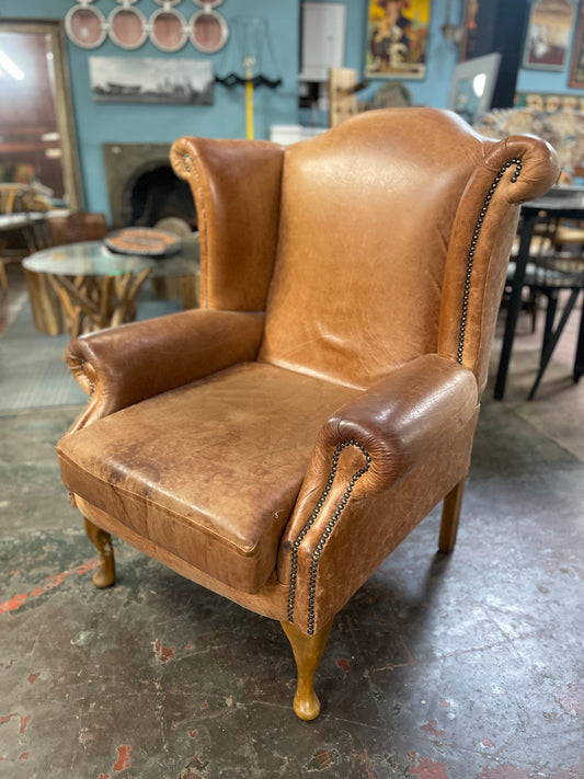 Tan leather wingback armchair