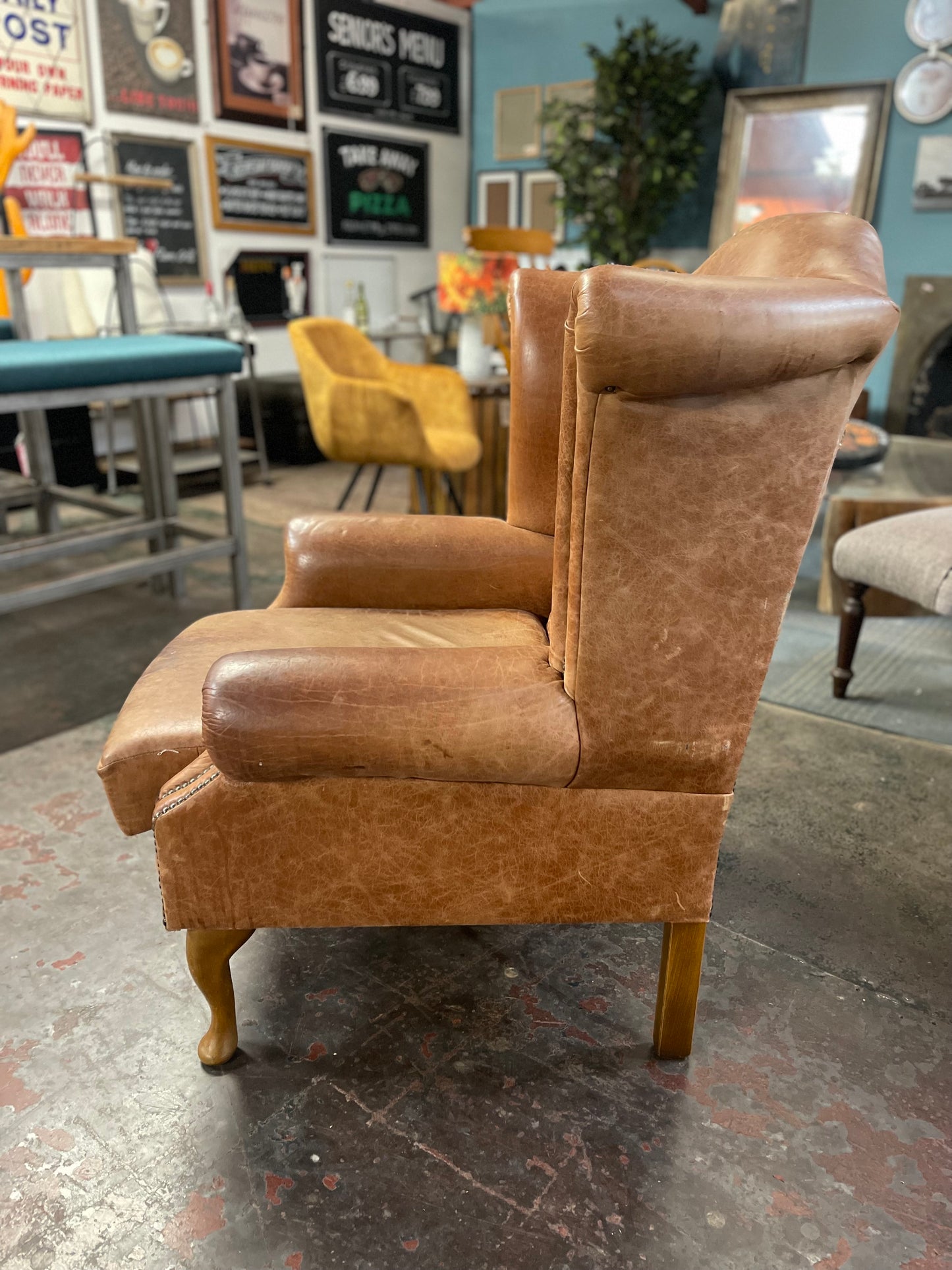 Tan leather wingback armchair