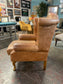 Tan leather wingback armchair