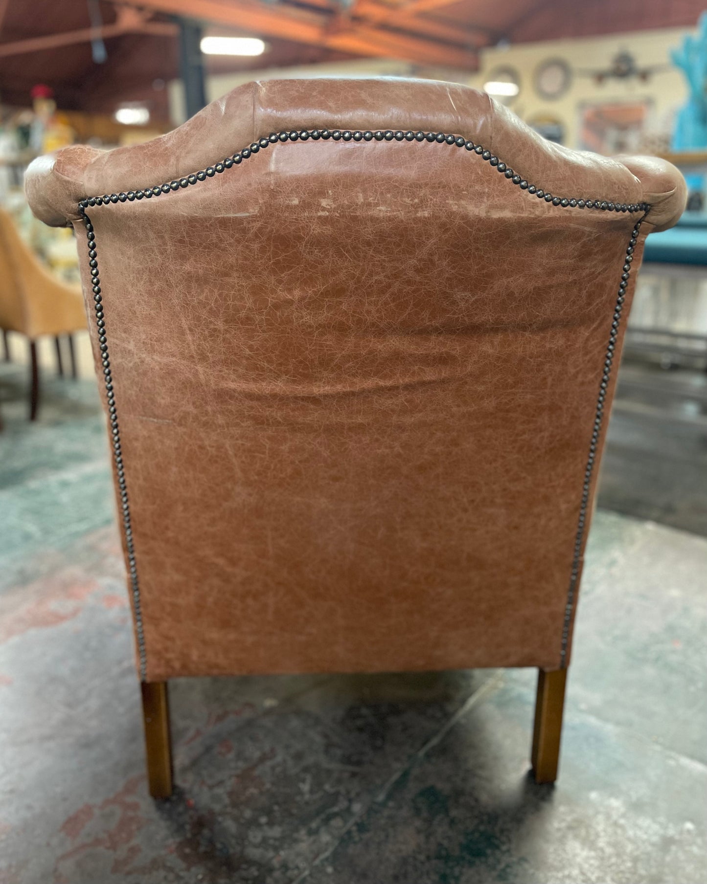 Tan leather wingback armchair