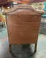 Tan leather wingback armchair
