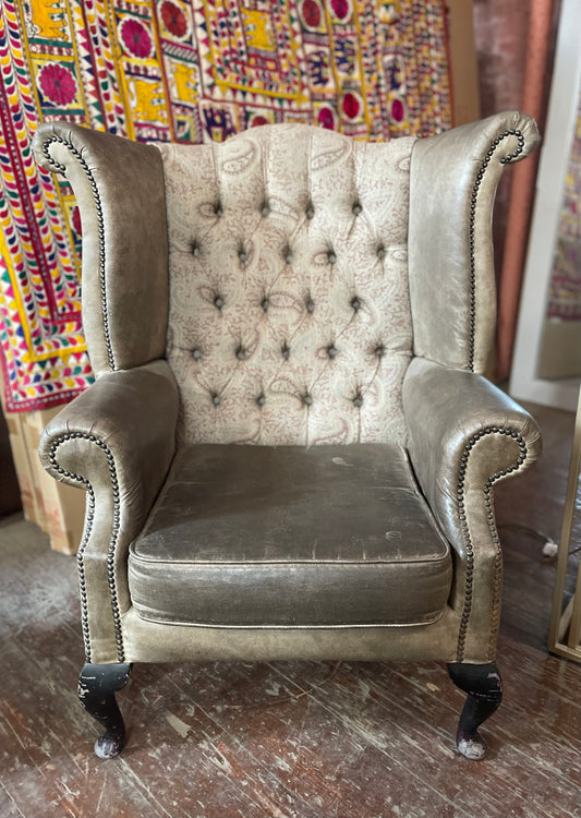 Grey wingback armchair with patterned fabric backrest