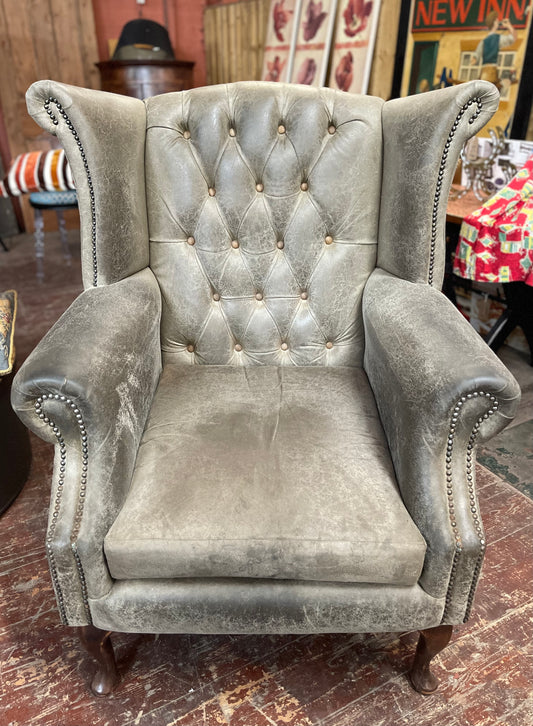 Grey Chesterfield style wingback armchair
