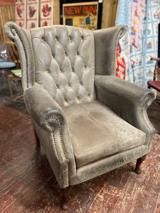 Grey Chesterfield style wingback armchair
