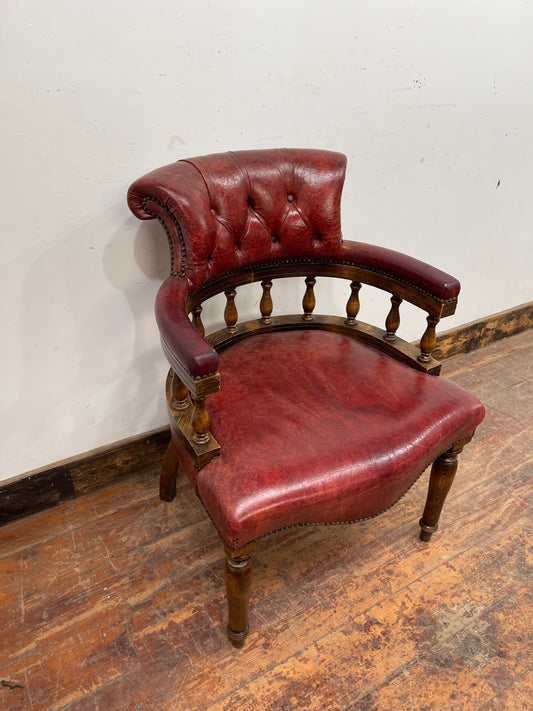 Stunning red leather captain's chair with wooden spindle back